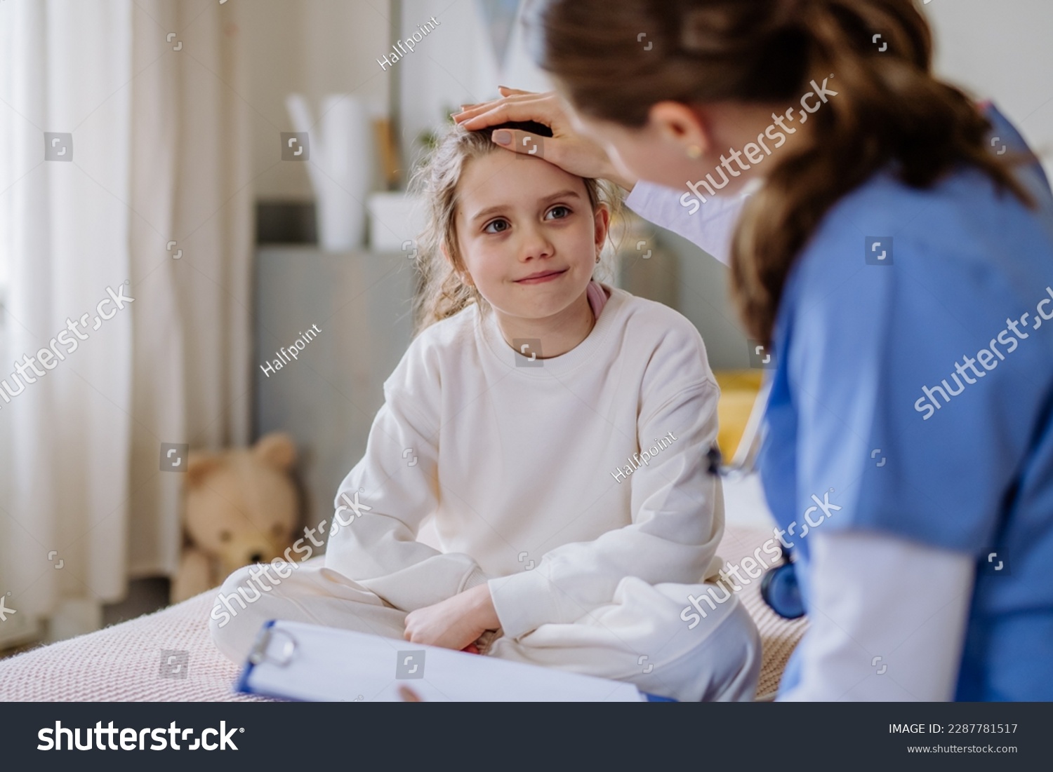 Nurse assisting a girl with an inhaler