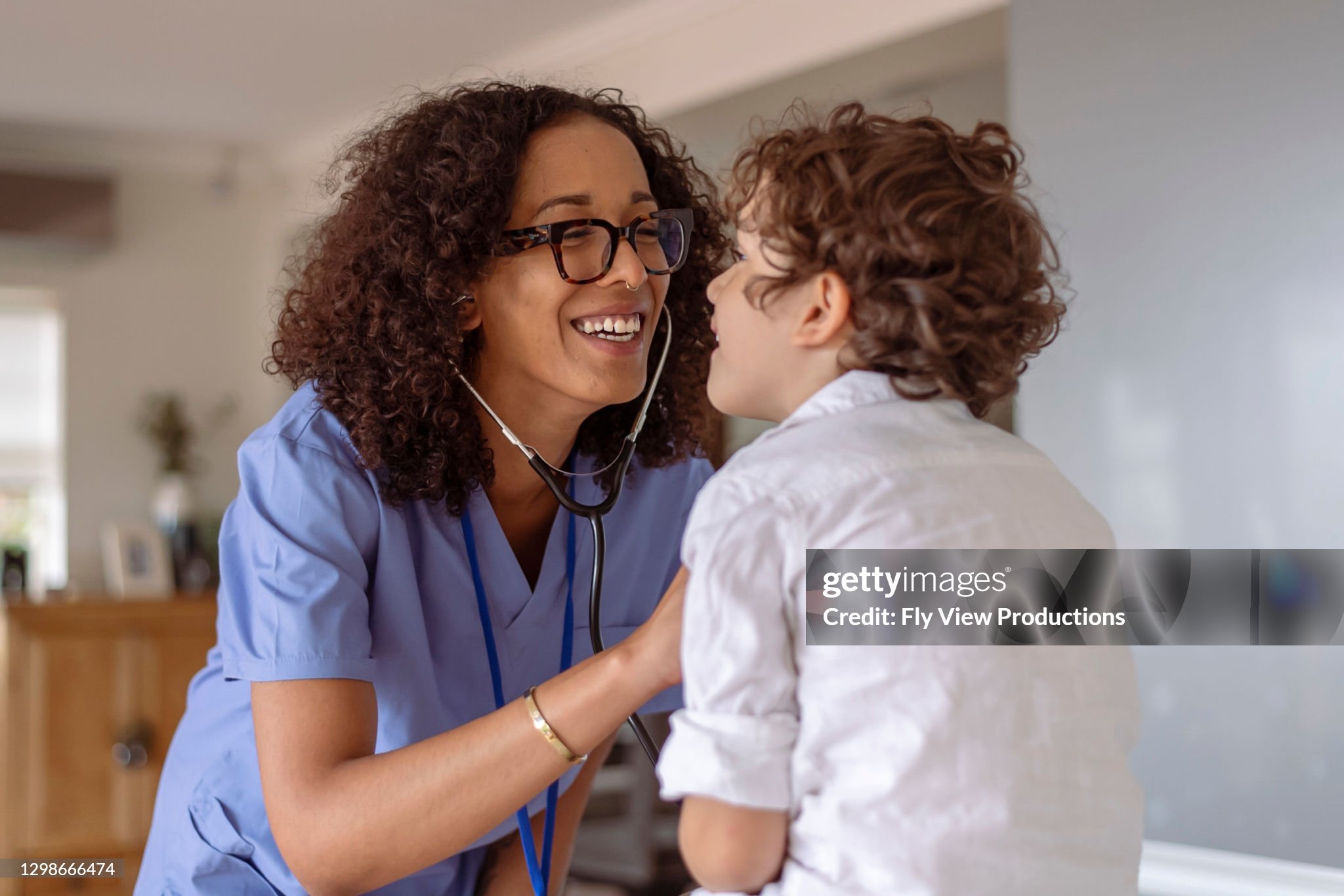 Nurse using a stethescope to find childs heartbeat
